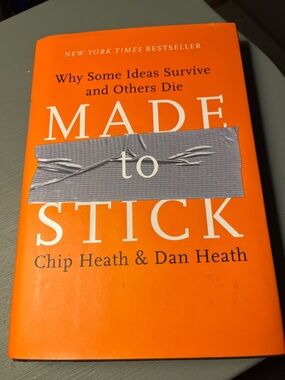 Made to Stick by Chip Heath & Dan Heath - Bright Orange Hardcover book